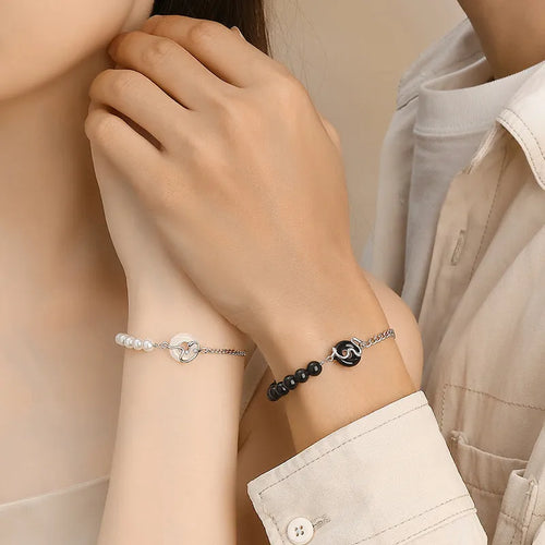 925 sterling silver couple bracelet with snake design and safety buckle on a wrist.