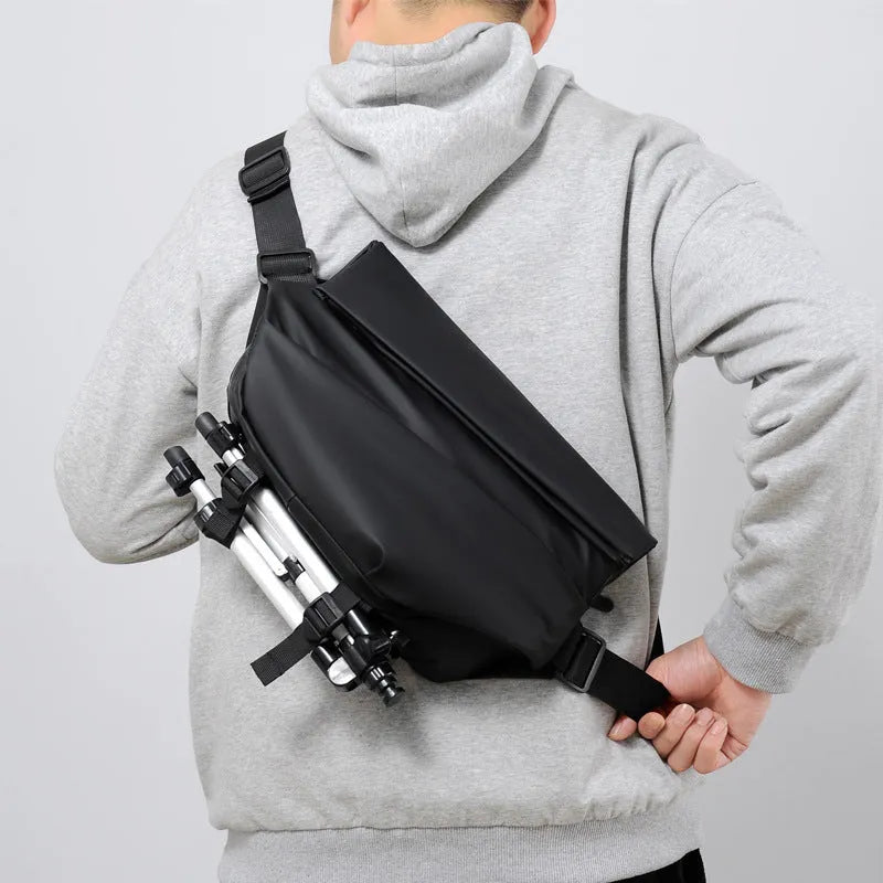 Men's grey medium crossbody bag with shoulder strap showing internal phone and document pockets