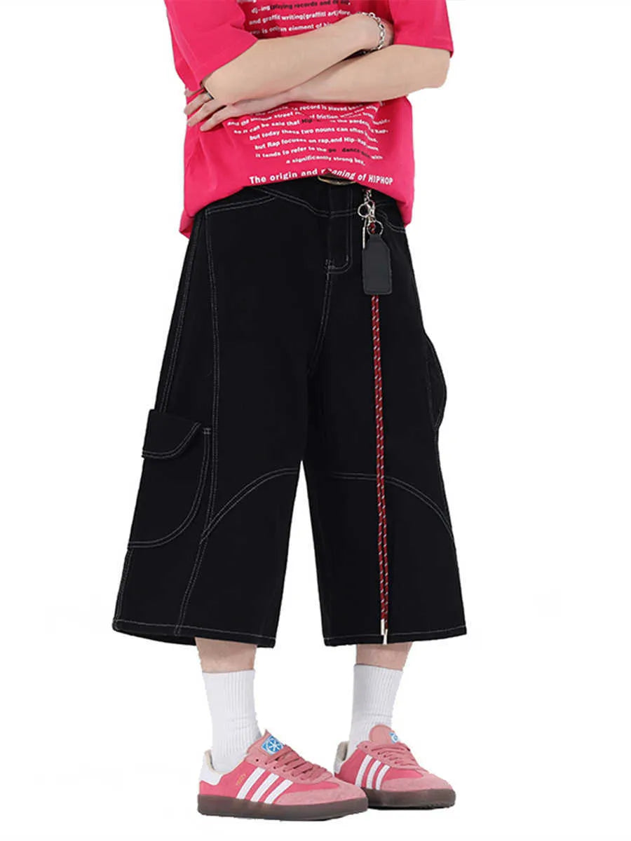 Black wide leg denim shorts with multiple pockets and cropped length on a mannequin
