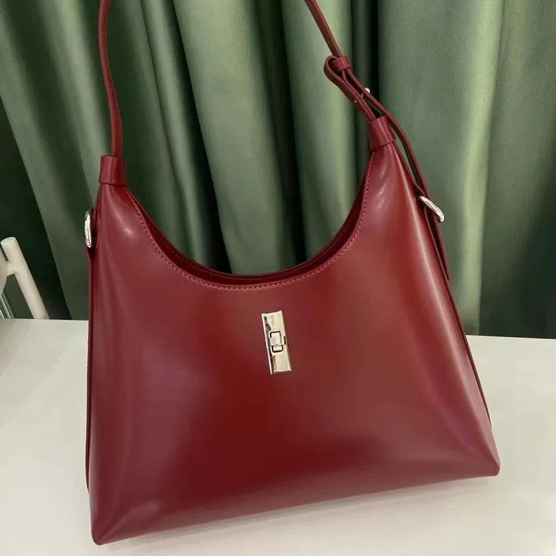 Soft genuine leather crossbody shoulder bag in dumpling shape with internal phone pocket and change compartment
