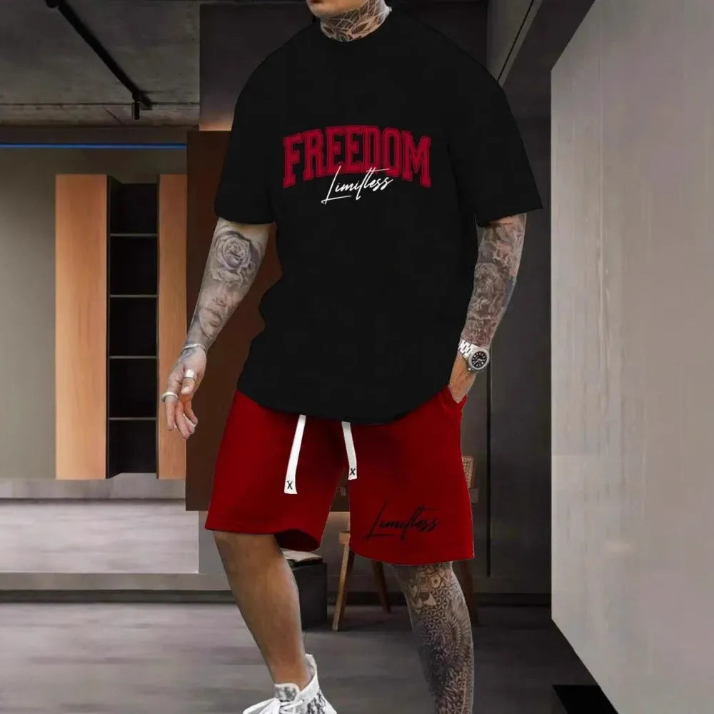 Man wearing a grey 3D printed letter short sleeve top and matching shorts from a sports co-ord set.