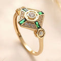 Square-shaped green emerald diamond fashion ring in ins style on a plain background.