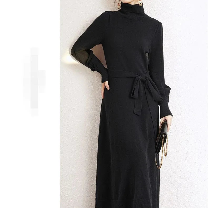 Turtleneck knitwear dress with elastic waist and loose mid-length skirt in solid colour.
