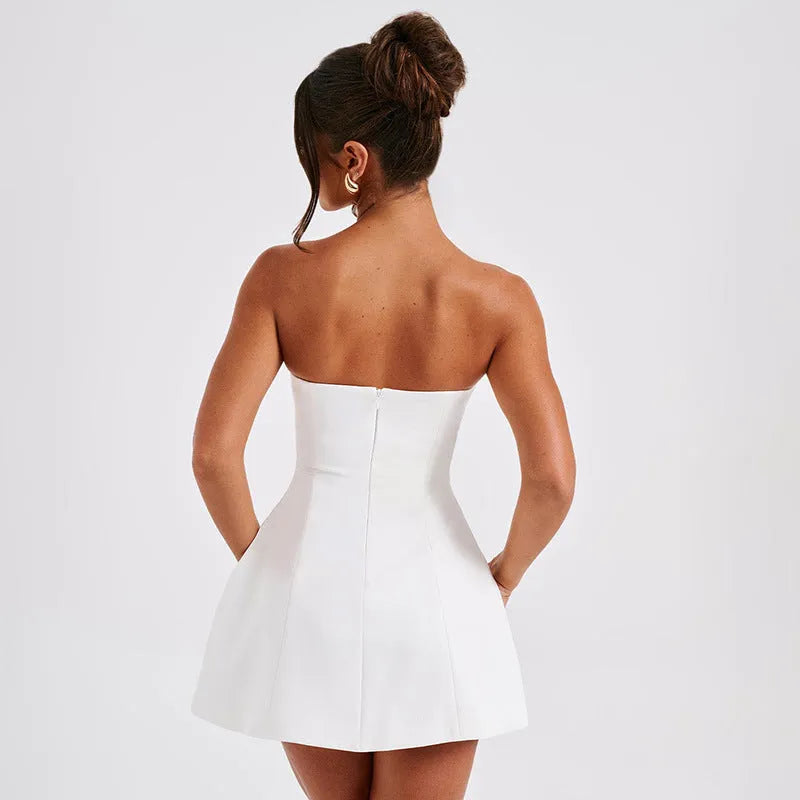 Women's backless solid colour A-line tube dress on a hanger, showing short length and high waist.