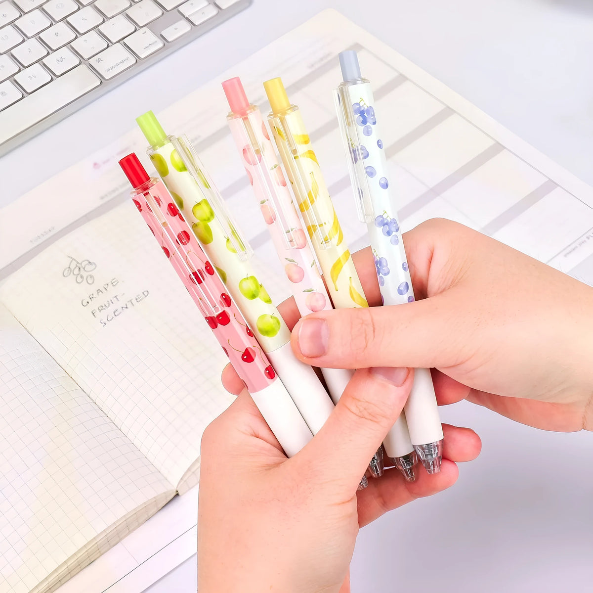 Three fruit scented pressurised pens with 0.5mm black ink and press-action mechanism