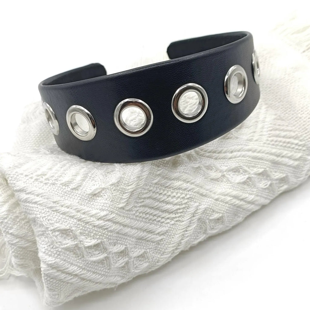 Black faux leather wide version women's headband with round, square, and dotted rivets