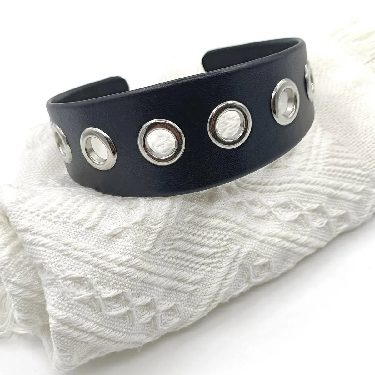 Black faux leather wide version women's headband with round, square, and dotted rivets