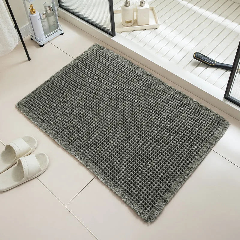 Checkered pattern non-slip absorbent bathroom carpet on a tiled floor.