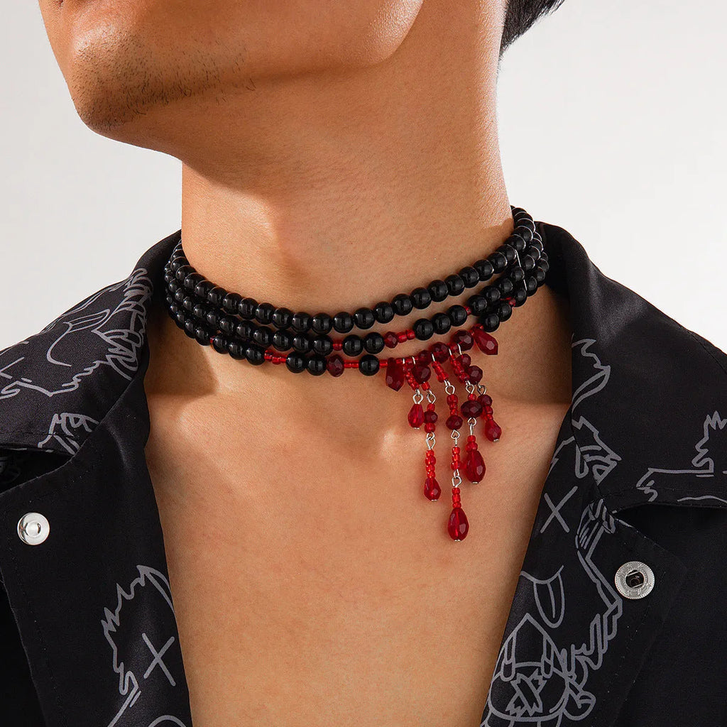 Men's blood drop tassel necklace with geometric crystal pendant and imitation pearls on a chain.