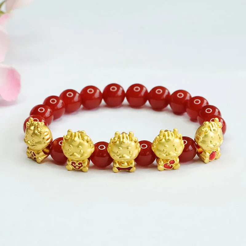 Close-up of a red agate bracelet with a carved five blessing dragon motif on 8mm beads.