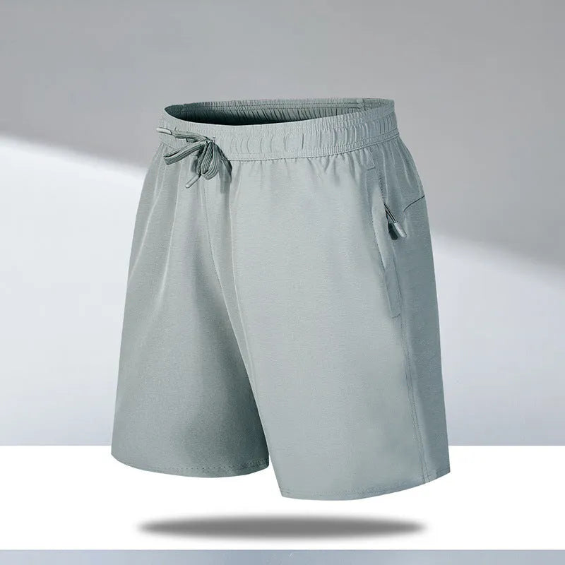 Man wearing loose light grey quick-dry polyester beach shorts on summer day
