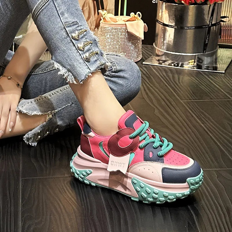 A pair of leather casual shoes with a thick wedge sole and round toe in a lace-up design.