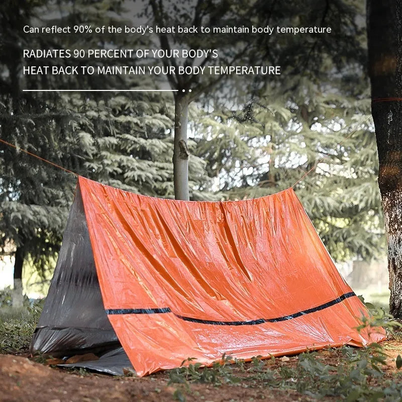 Portable orange disaster relief tent with sleeping bag and emergency blanket for outdoor use
