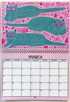 Cat-themed wall calendar with monthly date grid on paper for 2024 or 2025 planning