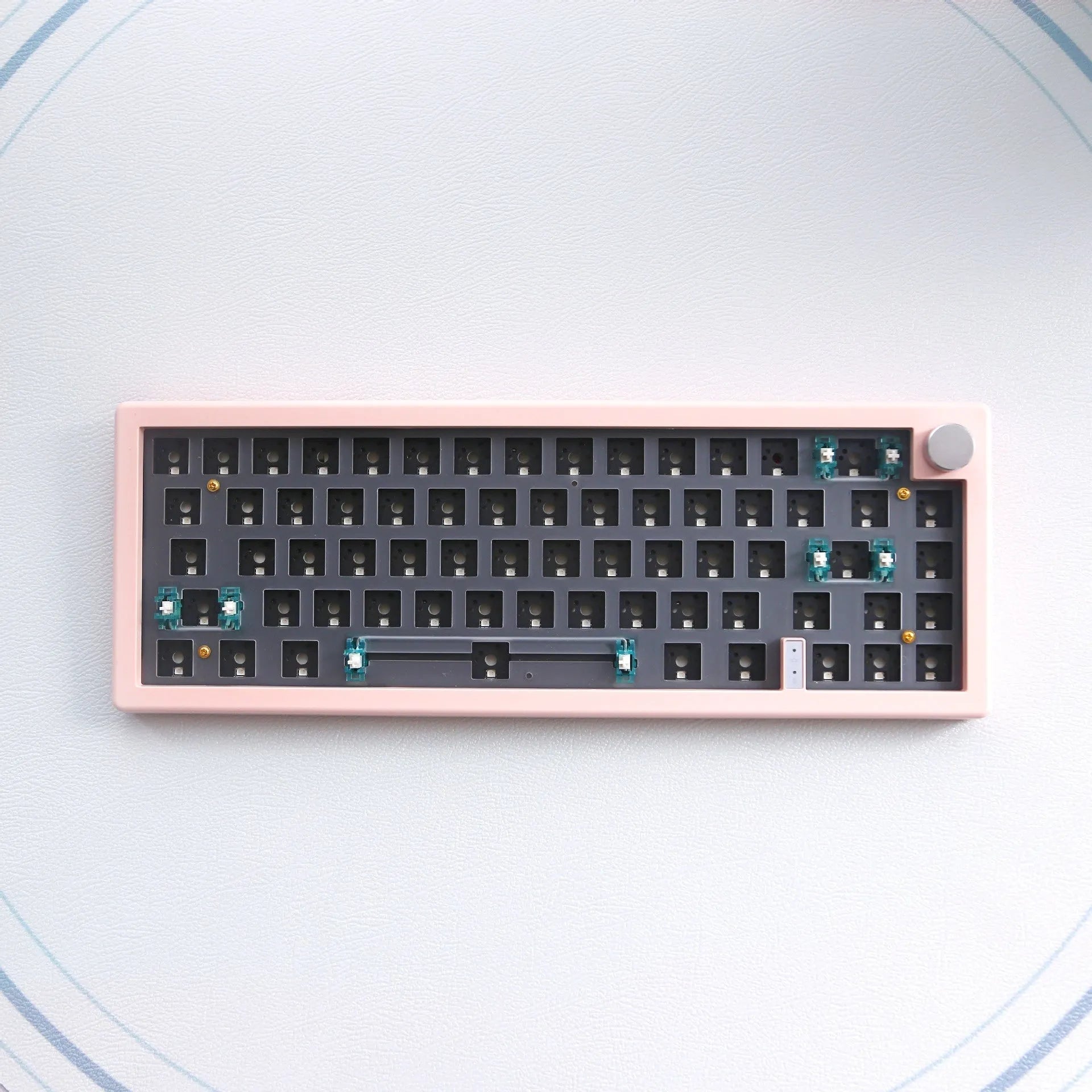 DIY mechanical keyboard kit with RGB lighting in seven colour options showing hot-swap sockets