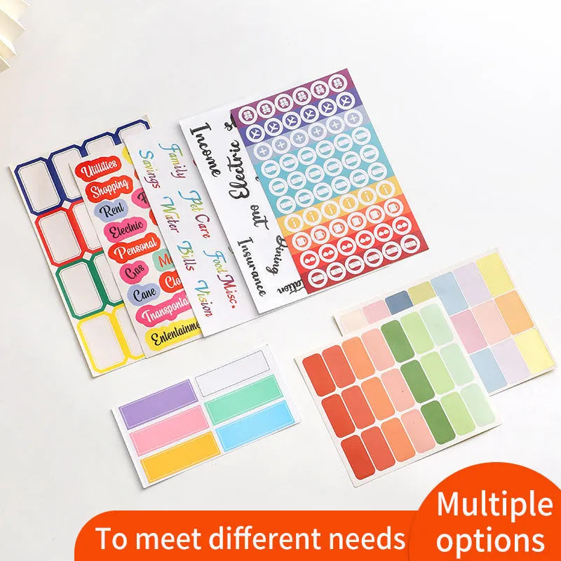 Assorted handwritten label stickers, A6 transparent ruler, grid stickers, and coloured sticky notes on paper.