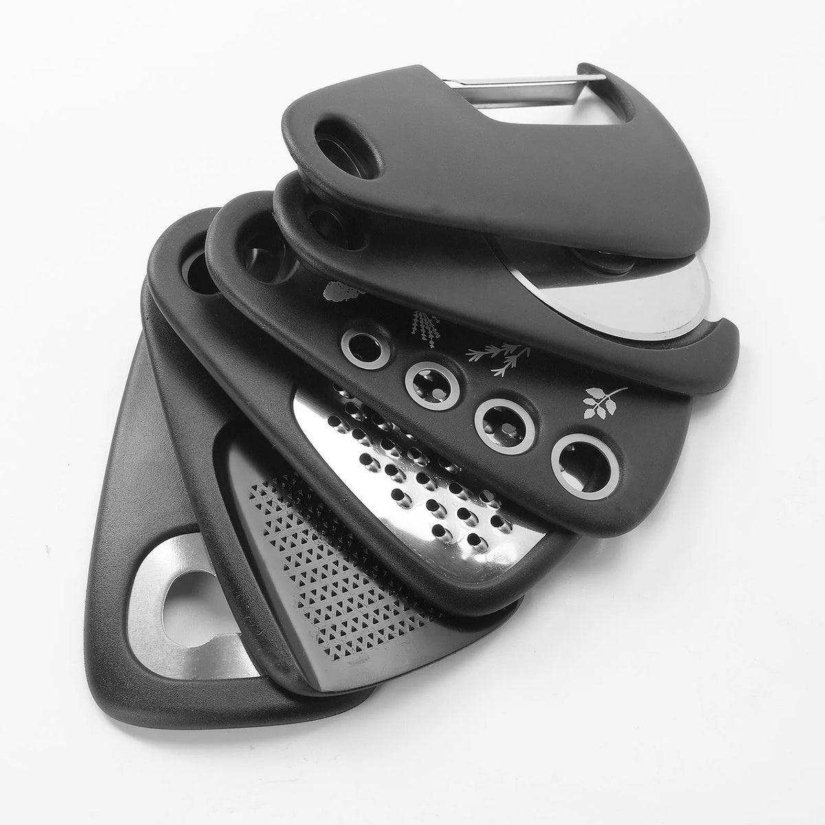 Six kitchen gadgets including wire whisk, dough scraper, potato peeler, garlic press, pizza cutter and bottle opener in colour box packaging