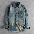 Man wearing a light blue loose-fit vintage denim shirt with long sleeves, cardigan style.