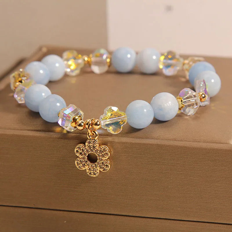 Women's aquamarine crystal four-leaf clover bracelet with pearl detail on adjustable silver chain