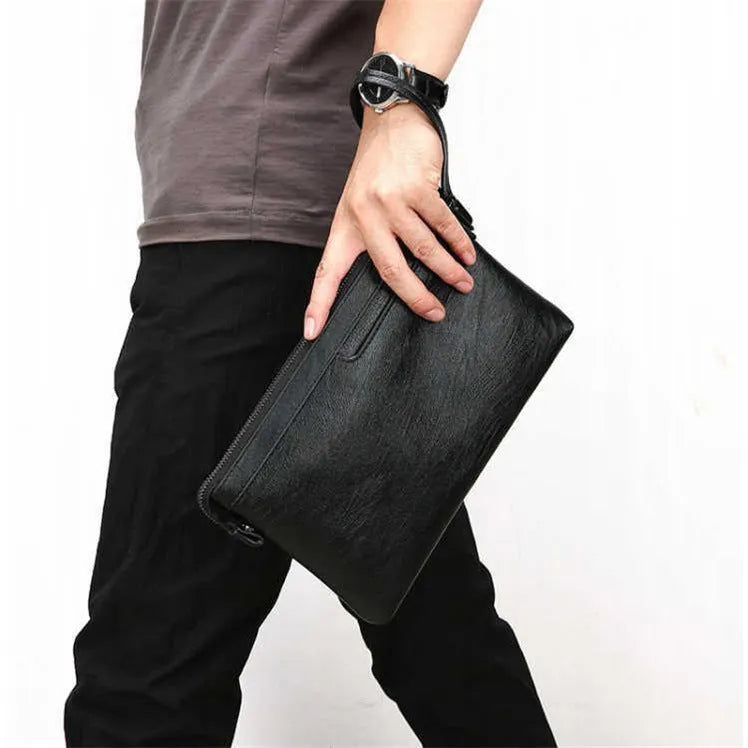 Men's PU leather clutch bag in black with wrist strap, soft carry handle, and zipper compartments