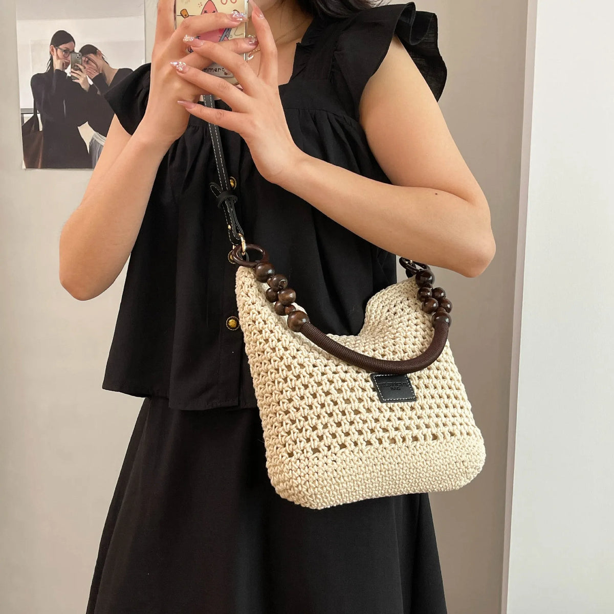 Knitted tote beach bag showing bucket shape, contrast stitching, and crossbody strap