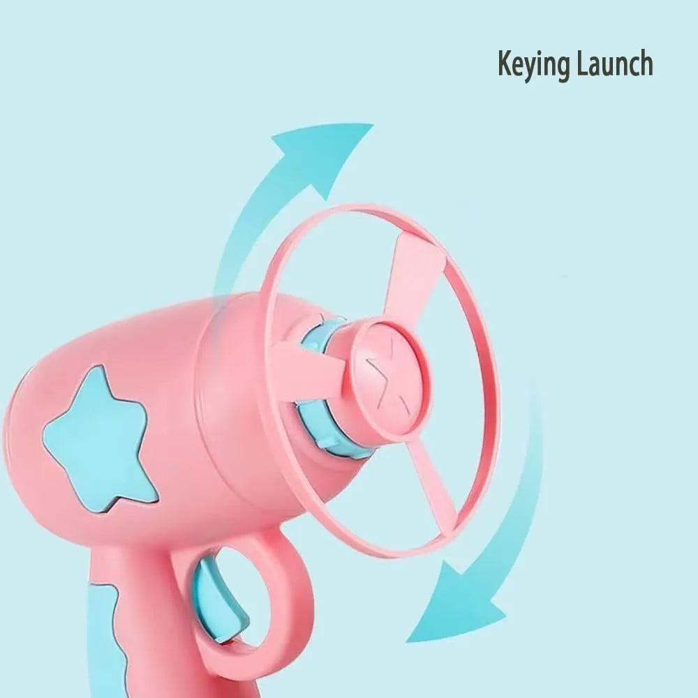 Blue plastic interactive cat toy gun with a mounted pink Frisbee on a table.