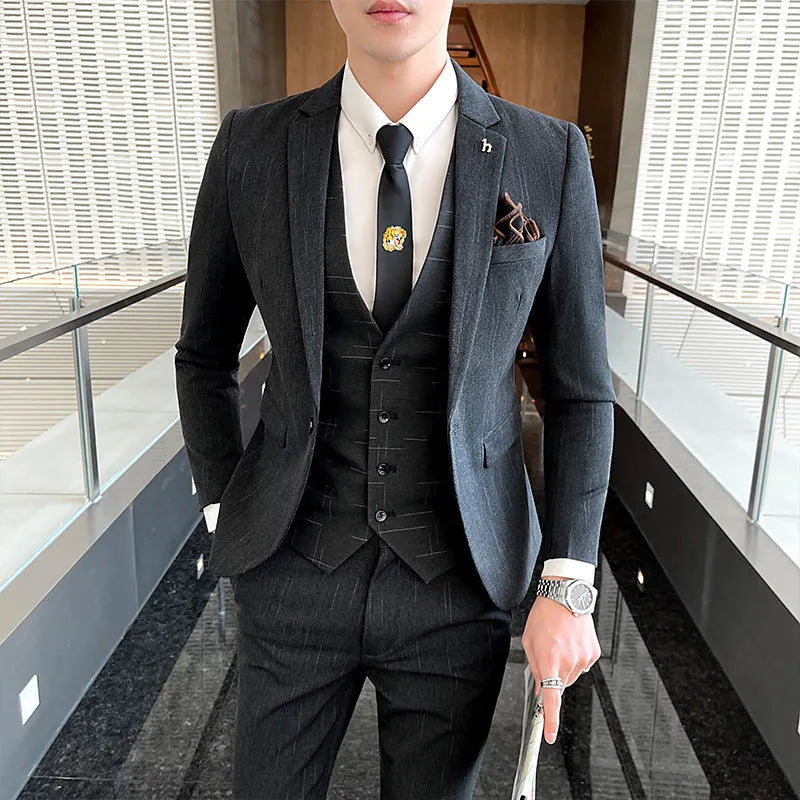 Men's slim fit black business suit jacket and trousers on a hanger.
