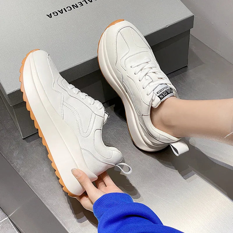 Beige women's cowhide leather low-top sports shoes with cross-strap and visible stitching on a round toe.