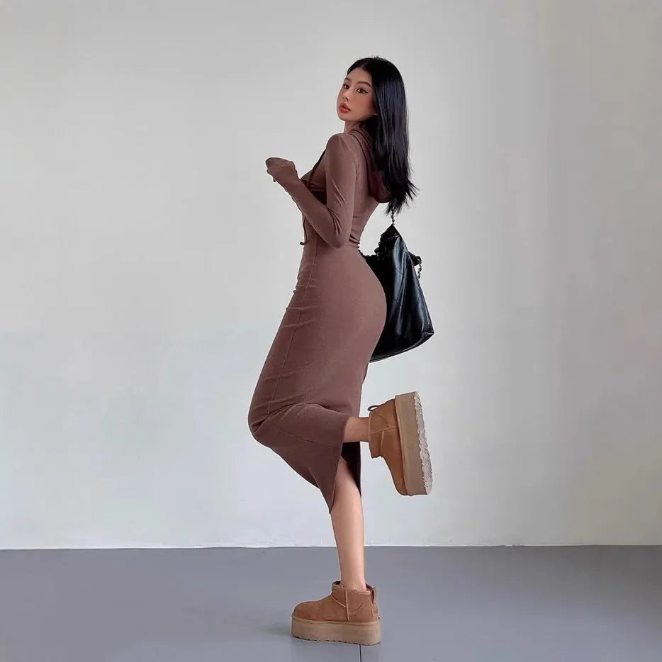 A woman's long sleeve hooded sheath dress in polyester, showing the high waist and over-the-knee length.
