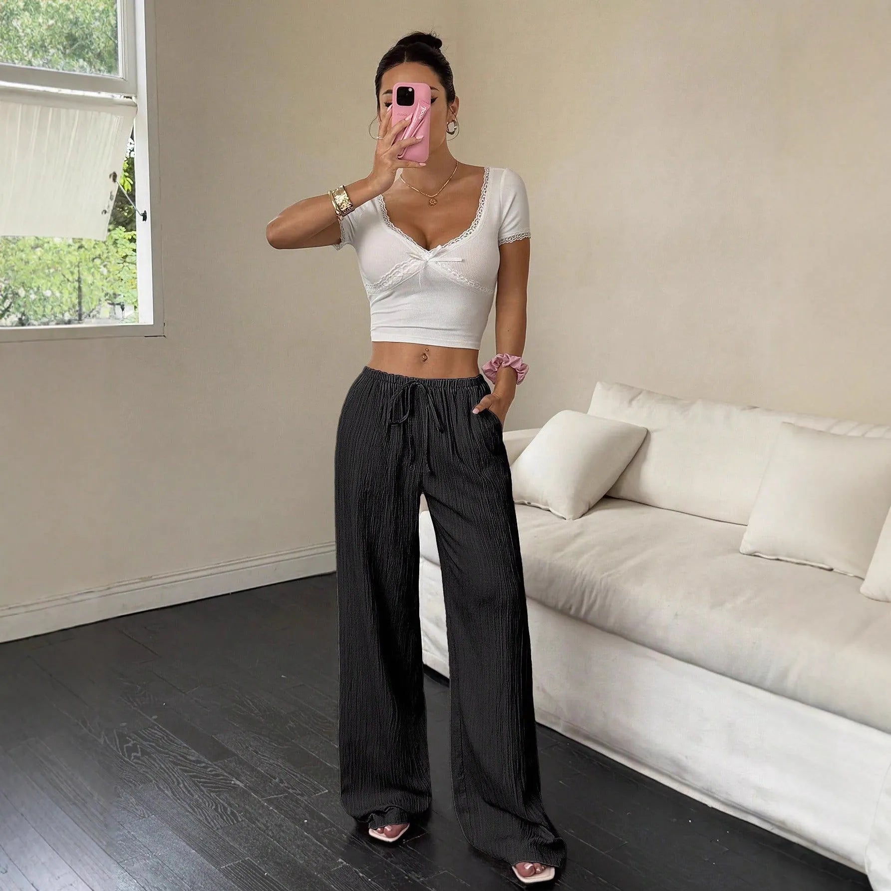 Women's black wide leg trousers with lace-up waist detailing on mid-rise waist