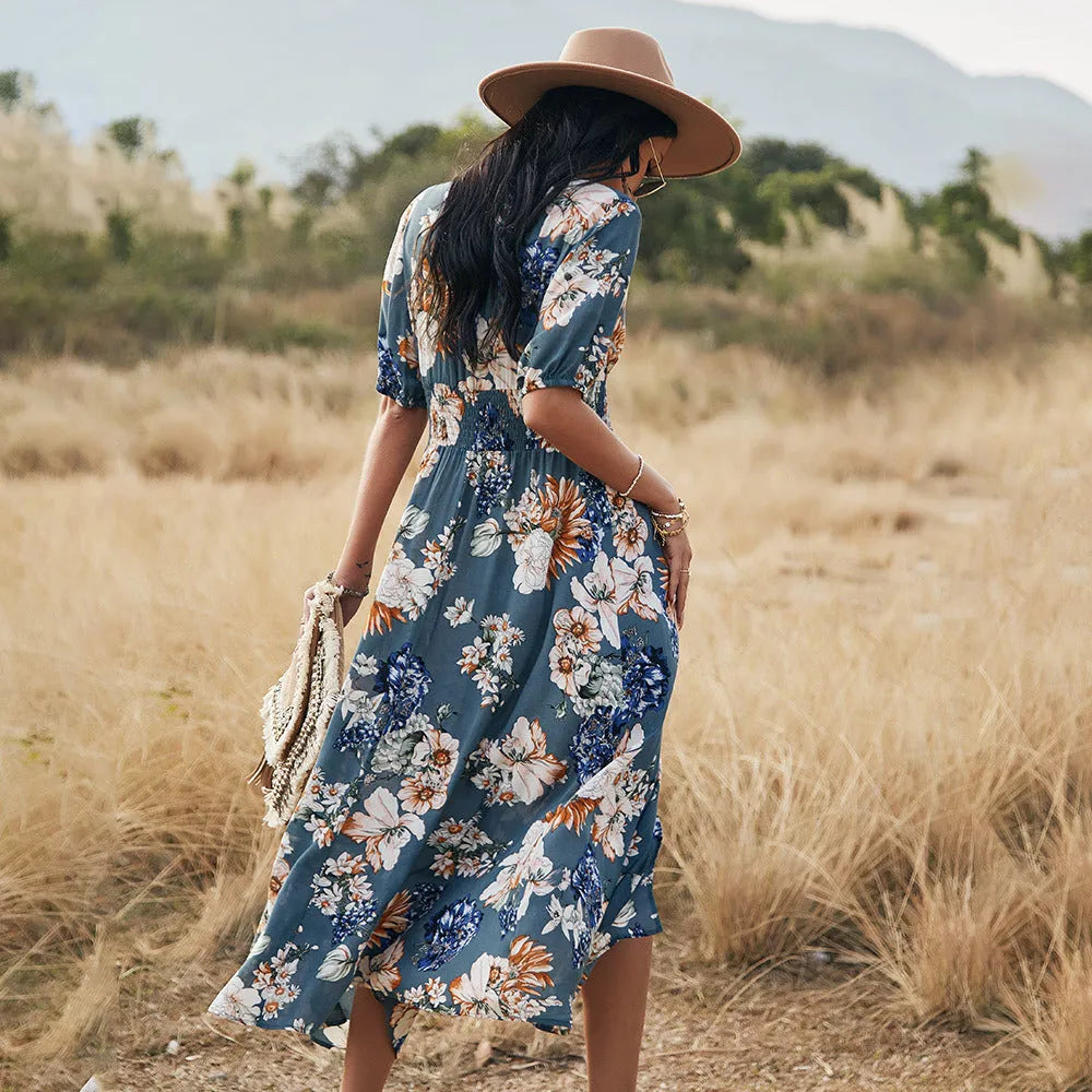 Yellow floral print summer dress with V-neck, short sleeves, and an elastic high waist on a mannequin.