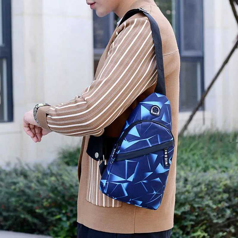 Men's medium blue Oxford cloth crossbody bag showing earphone hole and zipper opening.