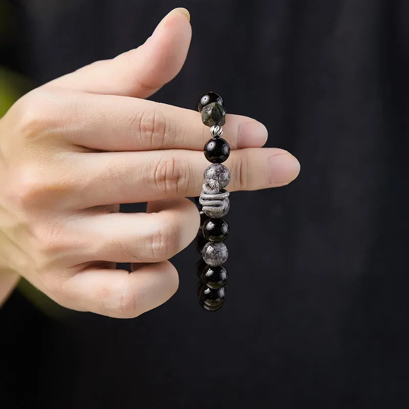 S925 sterling silver snake bracelet with obsidian black hair crystal centrepiece on wrist