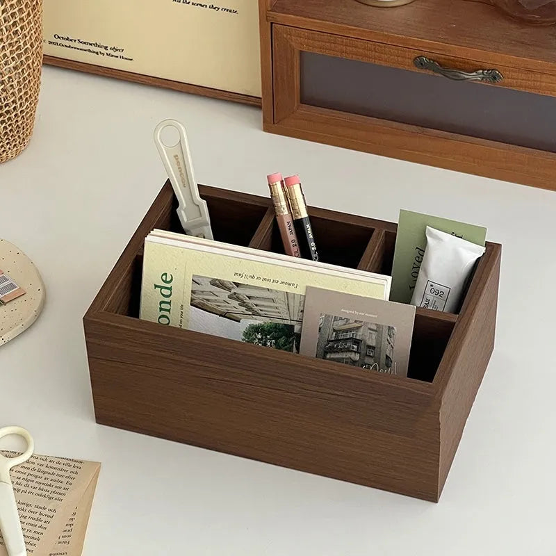 Retro wood desktop grid storage box with four short cells on a desk organising pens and sundries