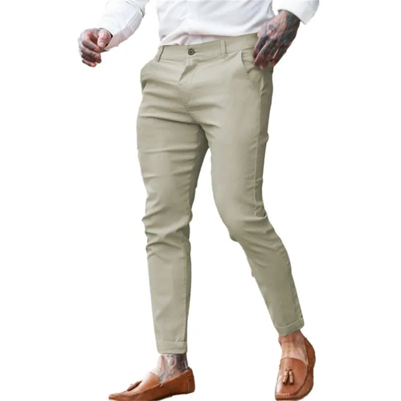 Men's slim fit stretch cotton pencil pants in a solid colour on a model.