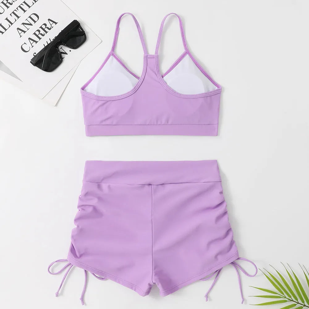 Women's purple high waist split bikini swimsuit with lining, showing top and shorts.