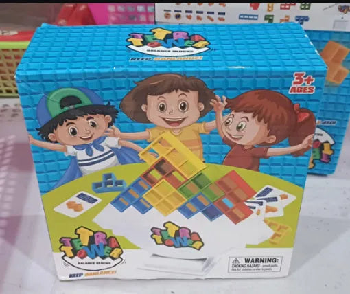 Plastic balance stacking game with 16 coloured blocks, chassis, and base on a table.