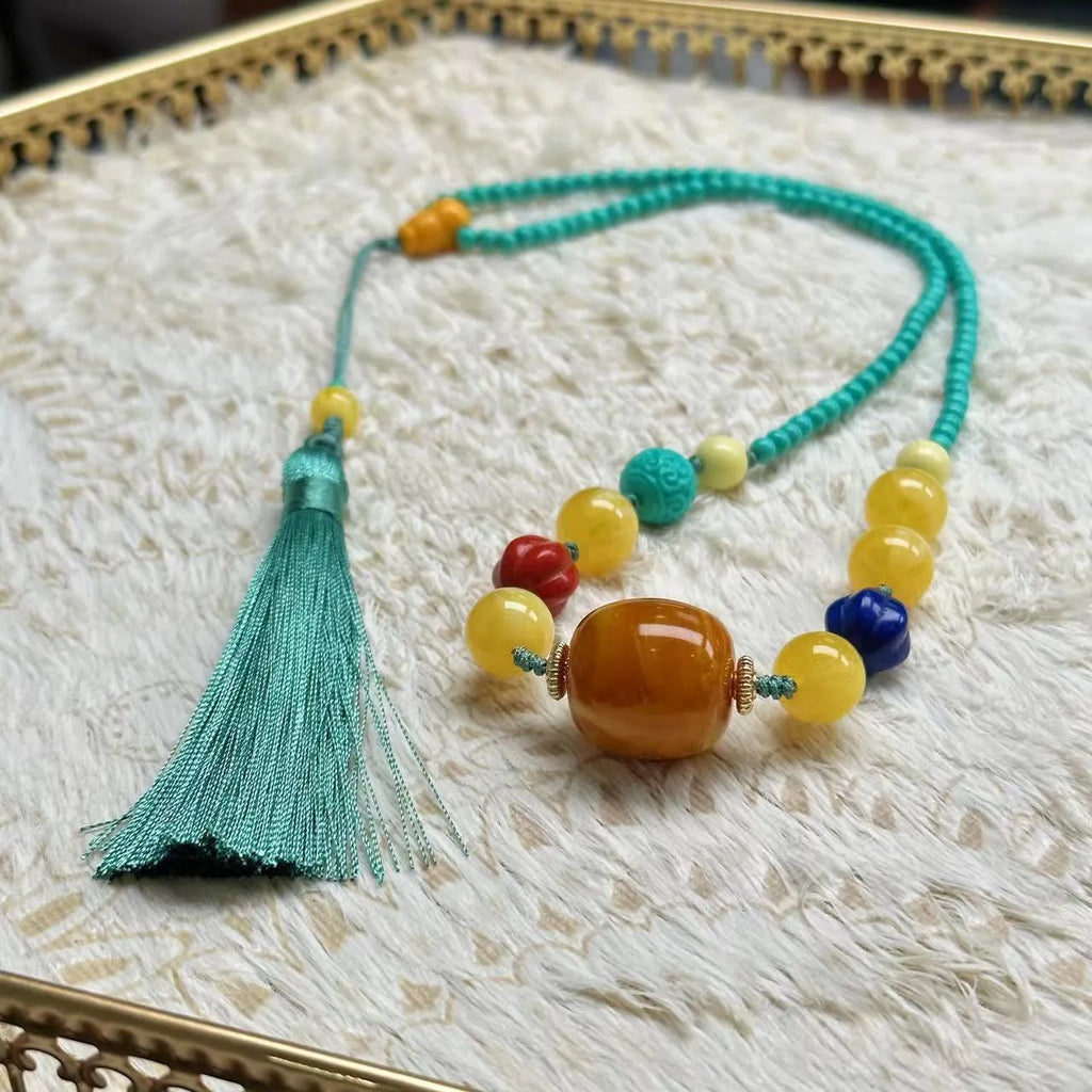Hand-woven turquoise mesh flower lucky pendant necklace on a ball bead chain.