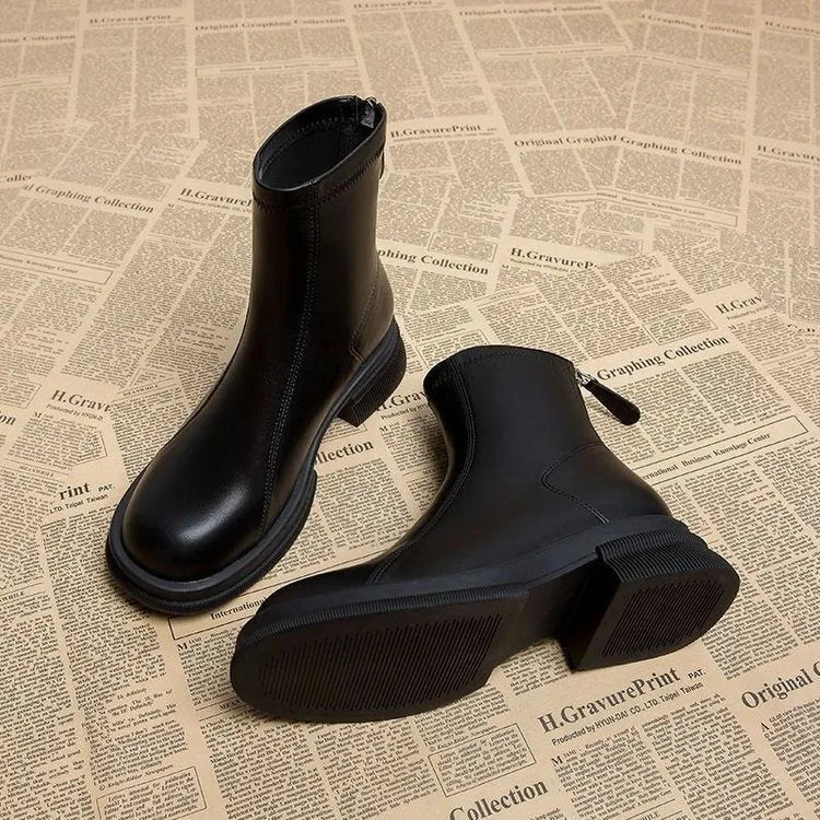 Women's black flat heel ankle boots with round toe and back zipper closure