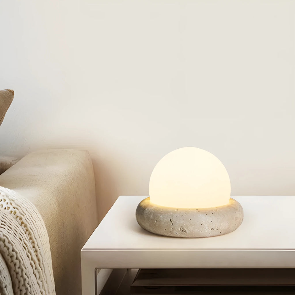 Modern simple bedside night light with remote control on a table.