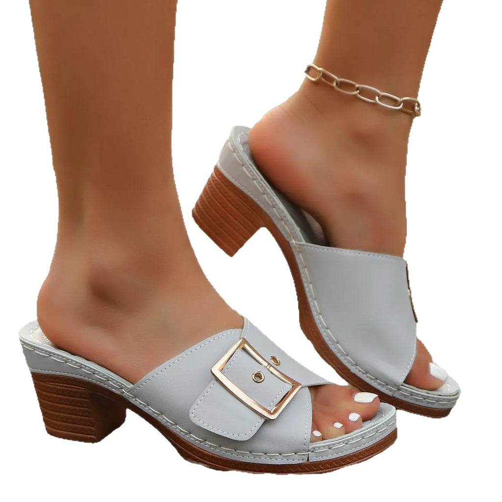 Women's retro style slippers with chunky heel and metal buckle detail in light blue colour
