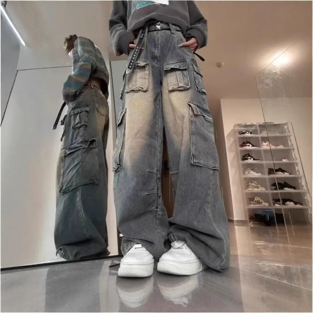 Men's loose fit multi-pocket denim jeans in distressed light blue wash with straight-leg street hipster styling