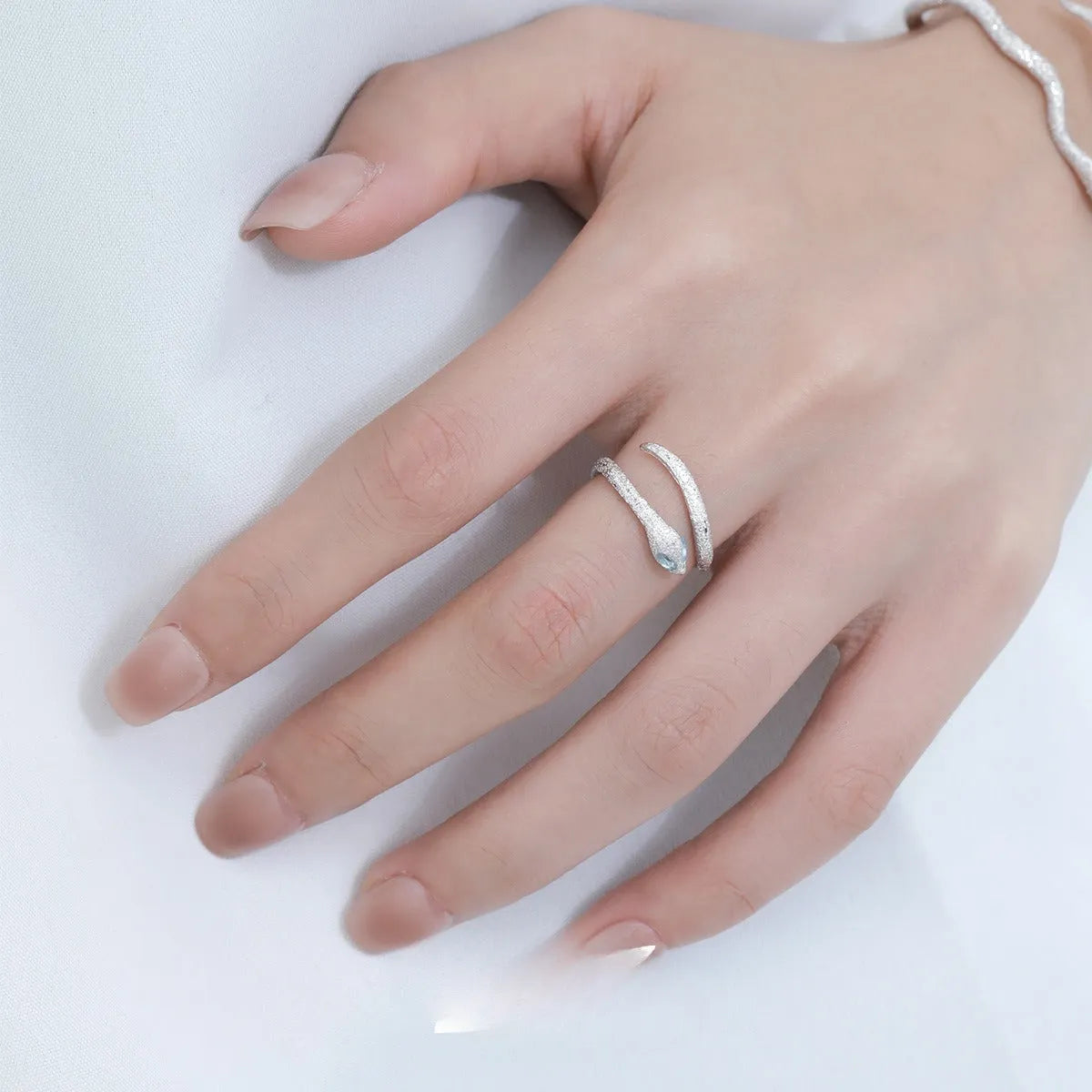 Silver adjustable snake ring with electroplated platinum finish and detailed zodiac design