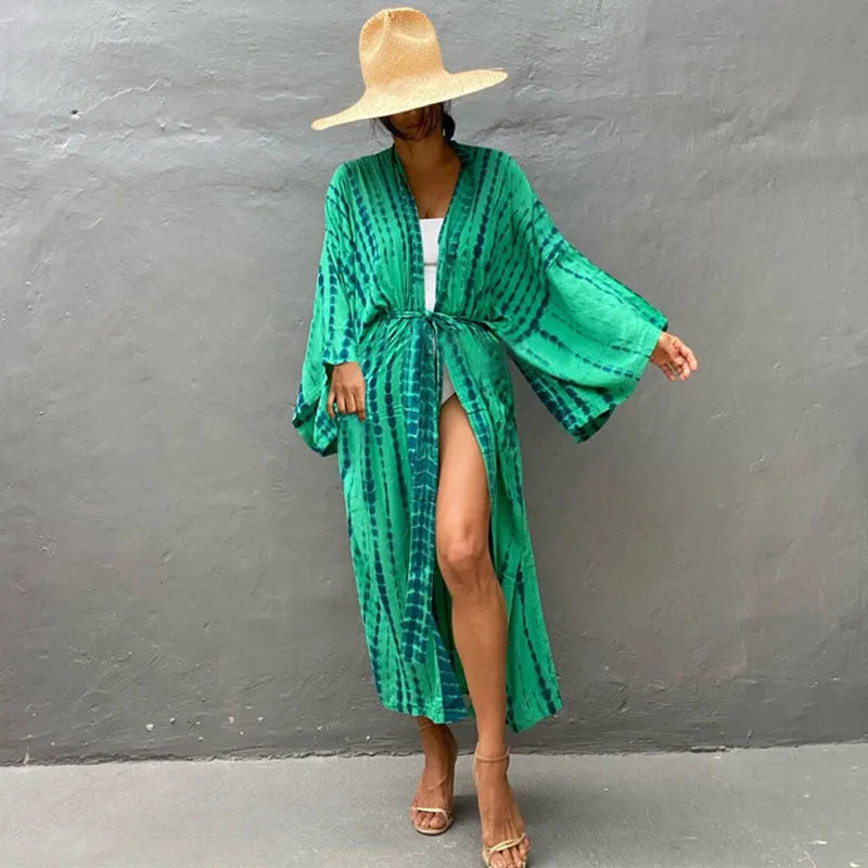A printed, loose-fitting cotton beach cover-up blouse on a hanger, shown in a rust red colour from the DN0712 series.