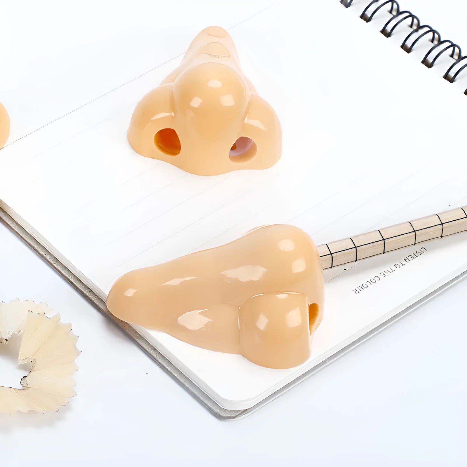 Flesh colour geometric plastic pencil sharpener with big nostril design measuring 58x45x30mm