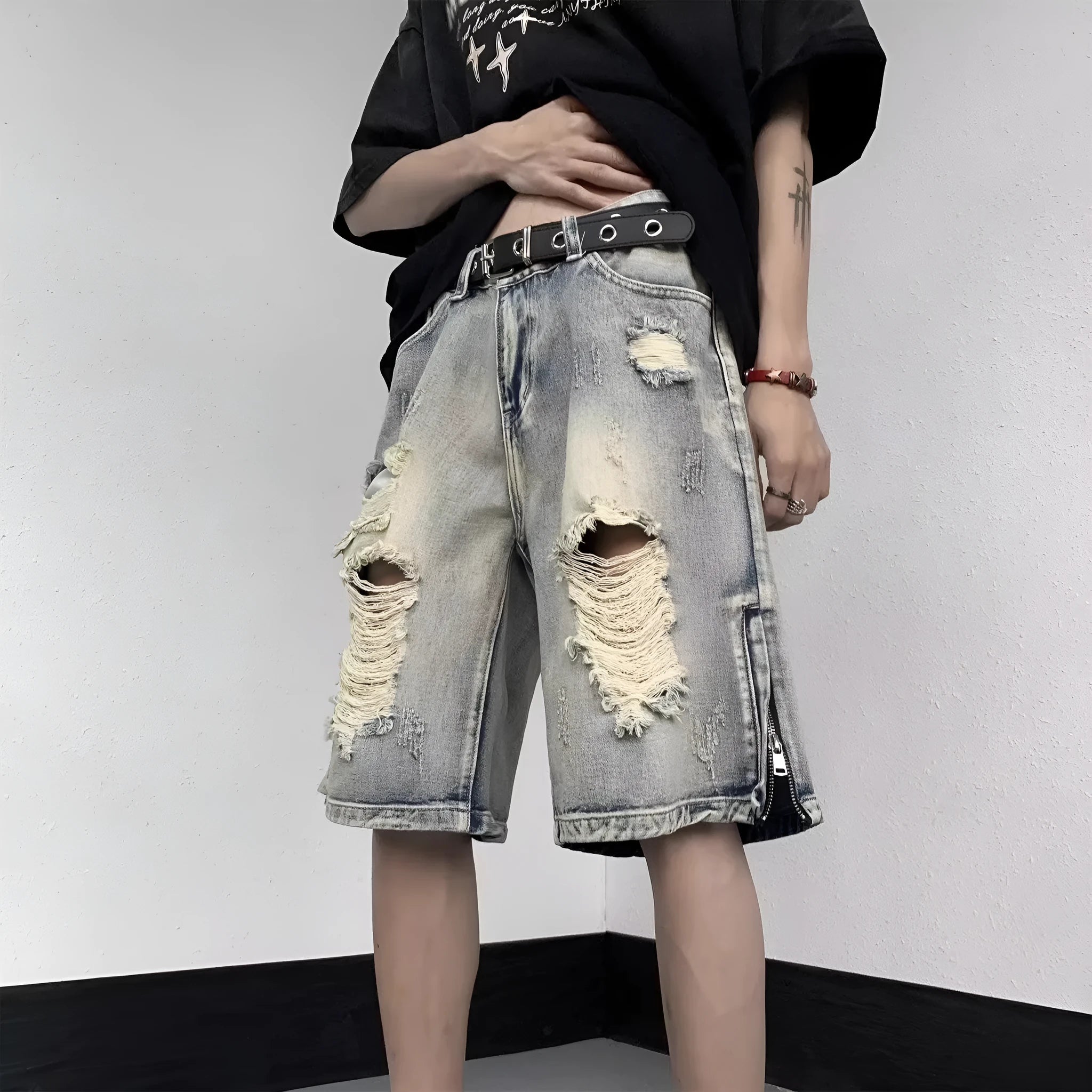 Blue retro-style tattered denim shorts with a wide leg loose fit on a hanger.