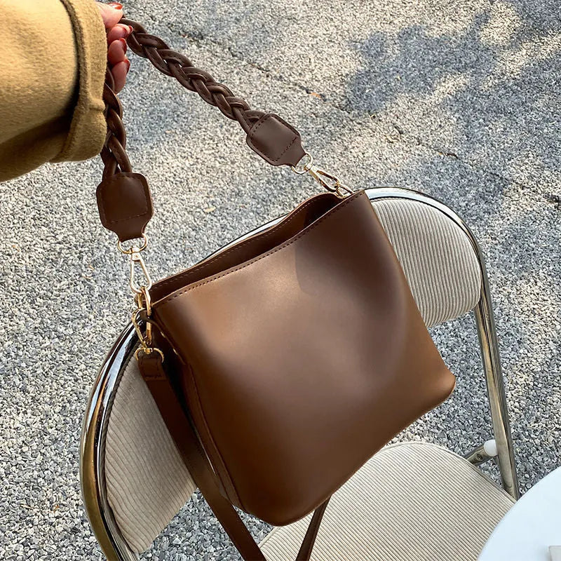 Retro unisex woven PU crossbody bucket bag shown in khaki colour.