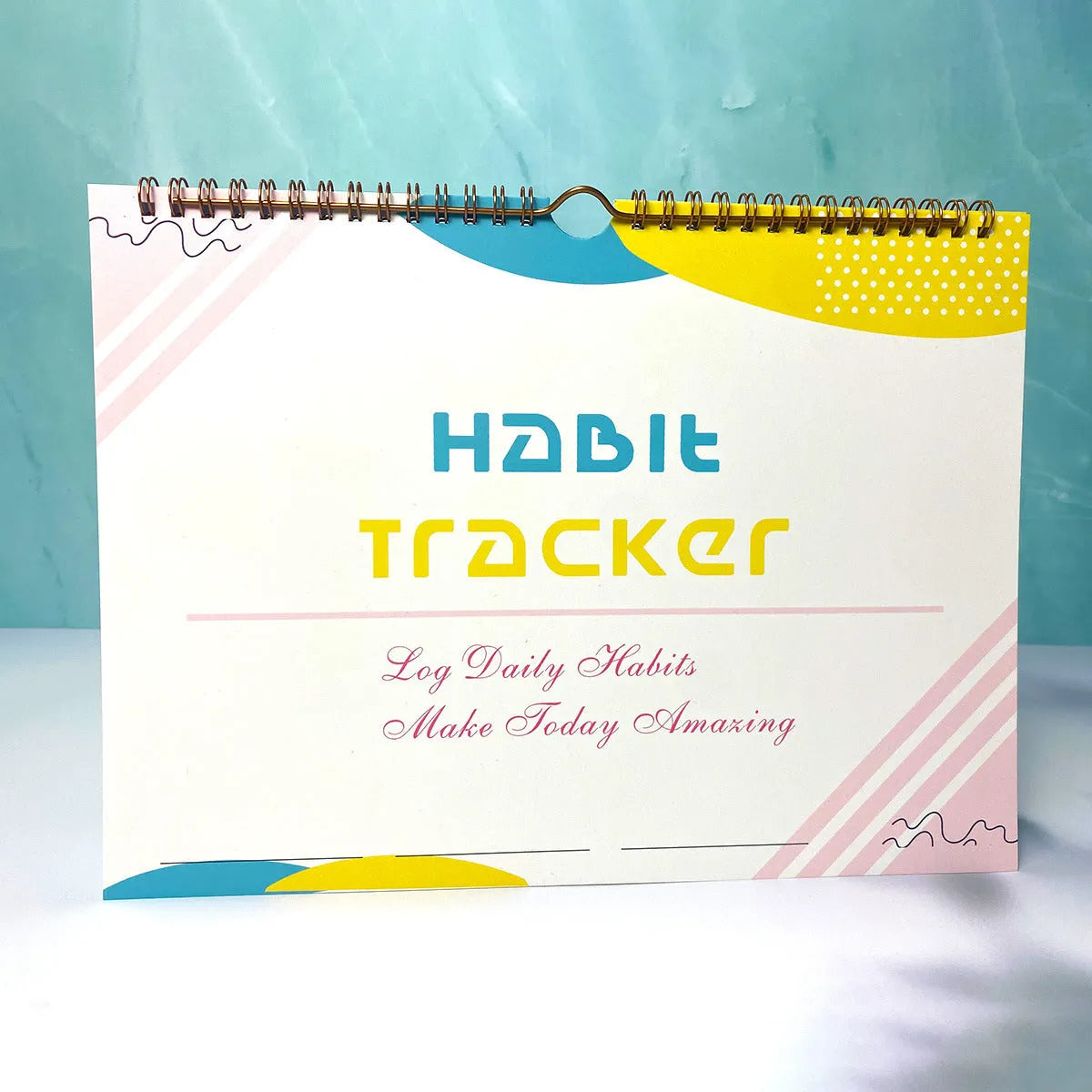 A4 habit tracking journal open showing 12 internal pages for schedule planning