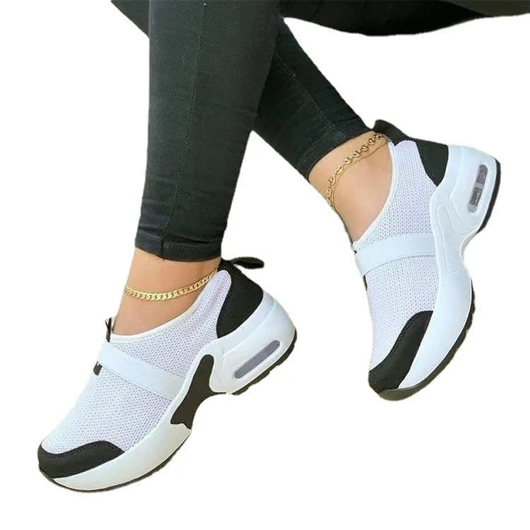 Women's white mesh flat sneakers with a round toe and non-slip rubber sole