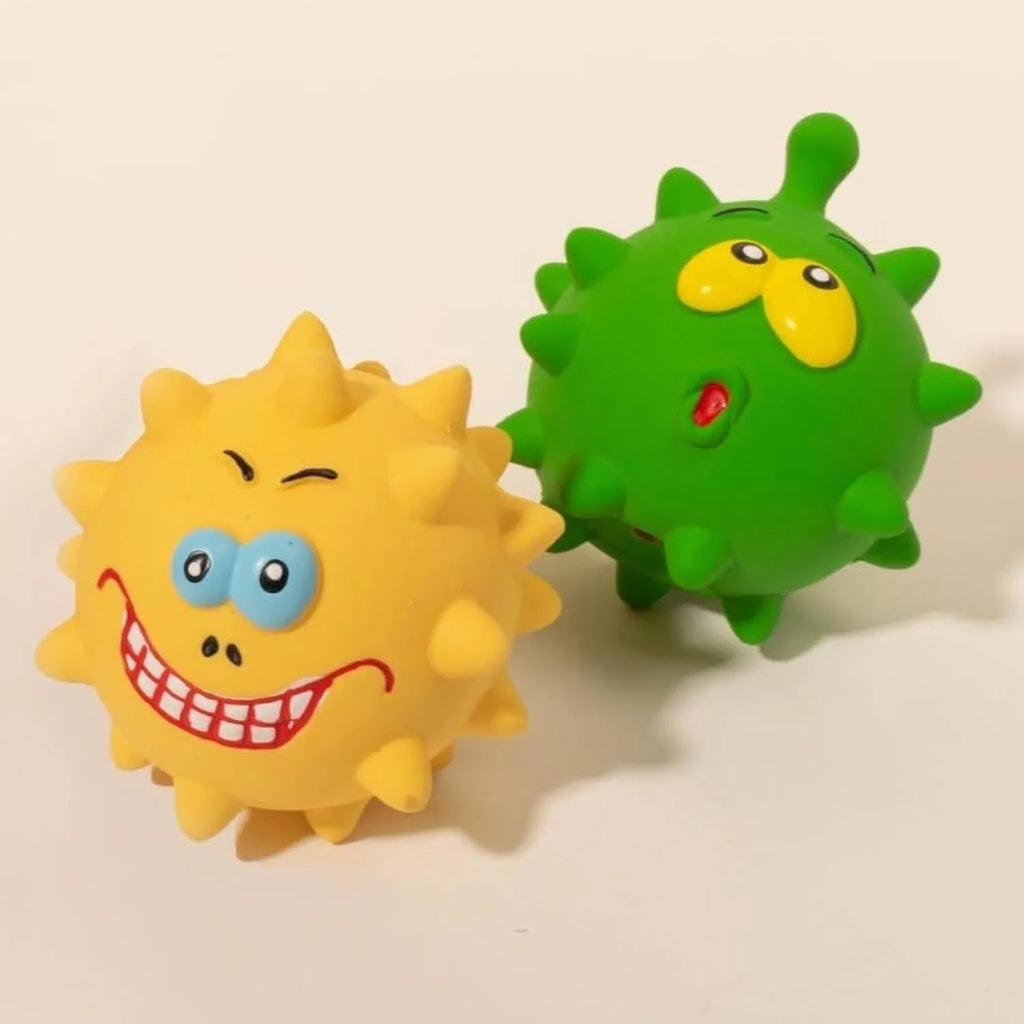 Set of four colourful squeaky latex dog balls with cute faces, shown next to a dog.